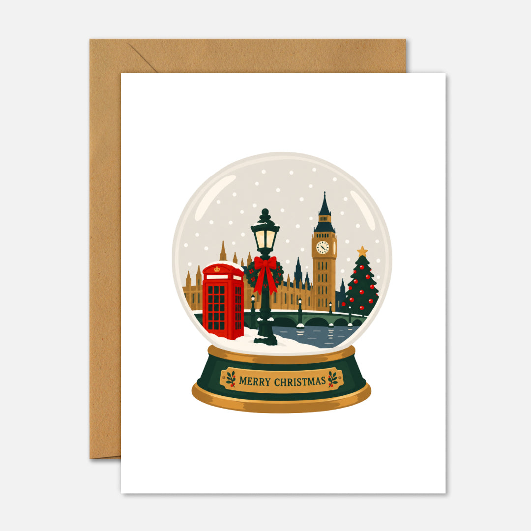 London Christmas Snow Globe greeting card featuring an illustrated London winter scene inside a snow globe with Merry Christmas written on the base.
