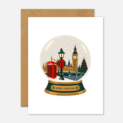 London Christmas Snow Globe greeting card featuring an illustrated London winter scene inside a snow globe with Merry Christmas written on the base.