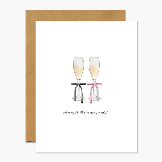 Greeting card with a champagne glasses design and "Cheers To The Newlyweds," perfect for wedding congratulations.