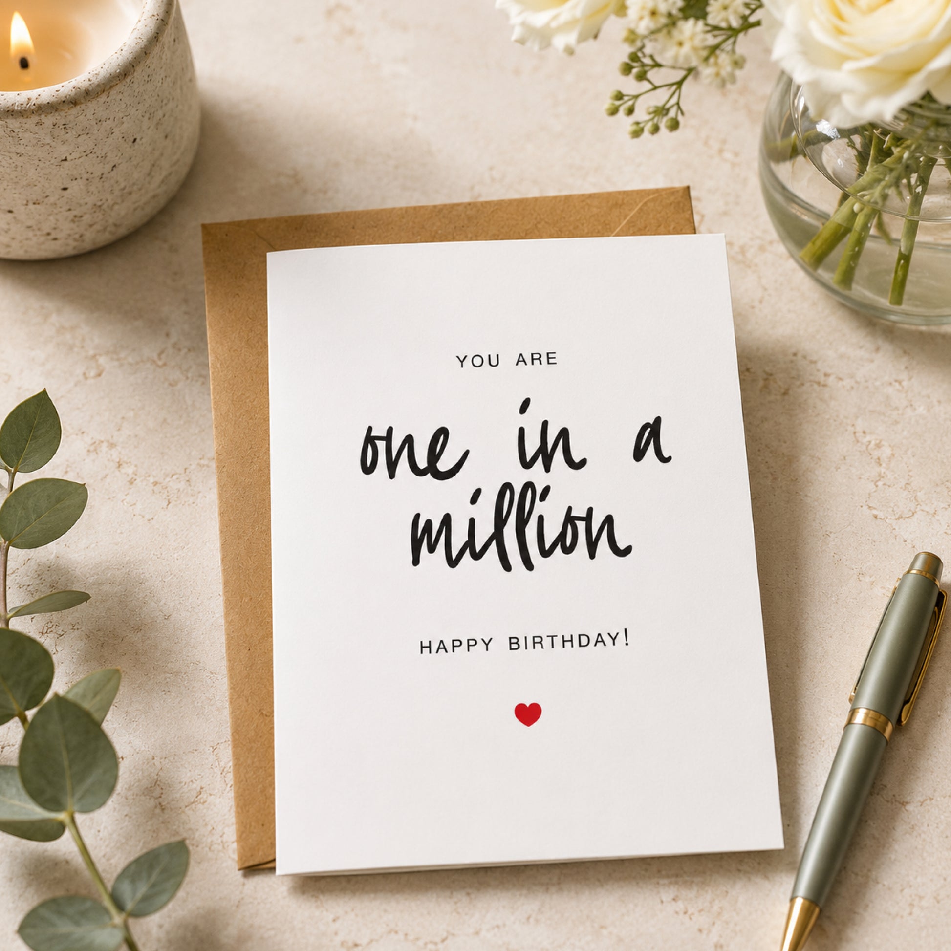 One in a Million birthday card with black hand lettered text and small red heart on a white card with kraft envelope.