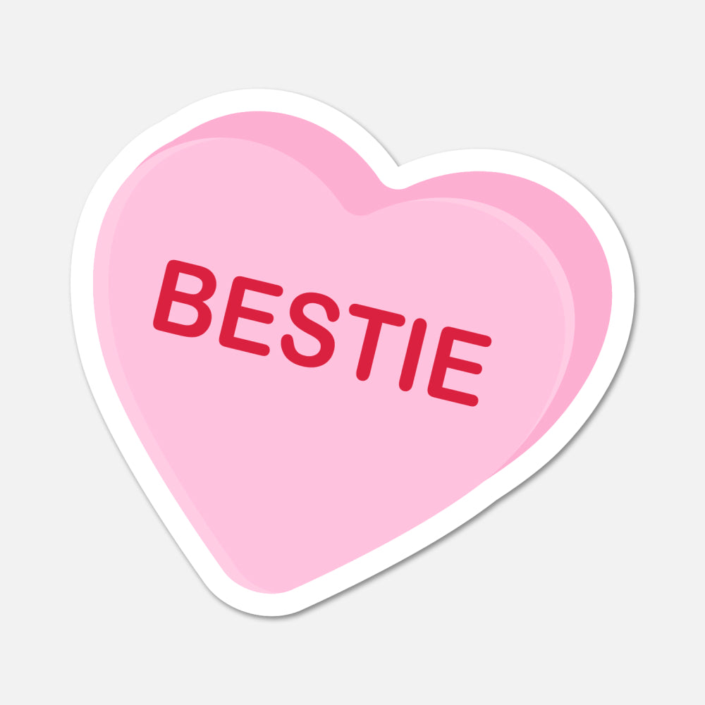 Heart-shaped pink sticker with 'BESTIE' text on a light gray background