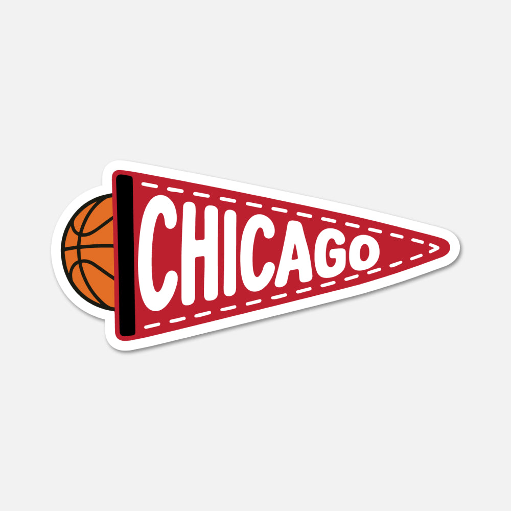A die-cut sticker or decal shaped like a red football-style pennant with white dashed stitching, the word "CHICAGO" in large white letters, and an orange basketball partially visible on the left, shown on a light gray background.