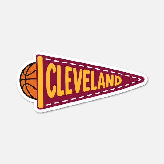 A die-cut sticker shaped like a retro basketball team pennant with the word 'CLEVELAND' in yellow letters on a maroon background, with a partial basketball visible on the left and a white outline, shown on a light gray background.