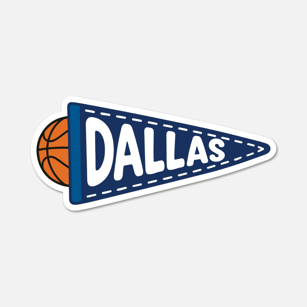 A die-cut sticker shaped like a navy blue sports pennant with the word "DALLAS" in large white letters, plus a partial orange basketball peeking out from behind on the left, shown on a light gray background.
