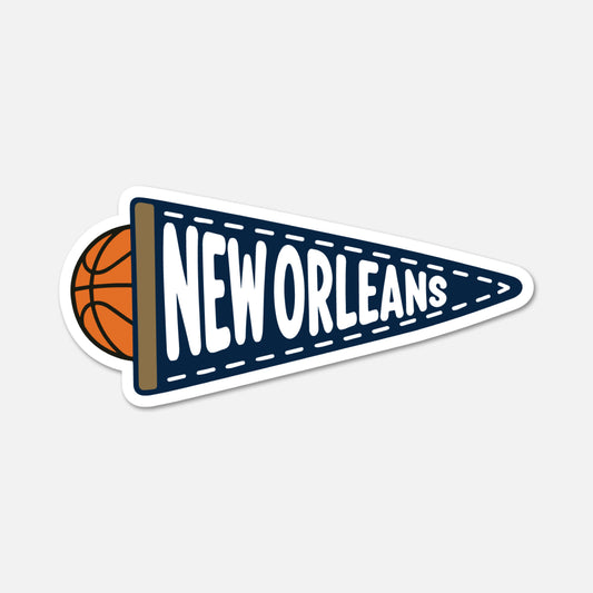 A die-cut sticker featuring a navy blue triangular pennant with white 'NEW ORLEANS' lettering, a brown wood-look border, and an orange basketball peeking out from the left, shown on a light gray background.