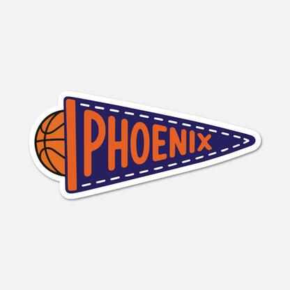 A die-cut sticker featuring a navy blue pennant with the word 'PHOENIX' in orange, alongside an orange basketball graphic on the left, shown on a light gray background.