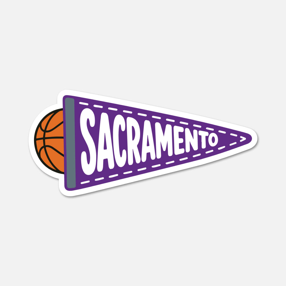 A die-cut sticker featuring a purple triangular pennant with the word 'SACRAMENTO' in white outlined letters, attached to an orange basketball, shown on a light gray background.