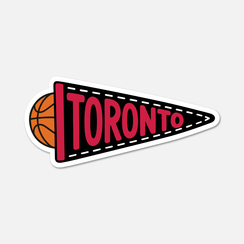 A die-cut sticker shaped like a retro triangular pennant with the word TORONTO in large red letters on a black field, outlined in white. A small orange basketball peeks out from the left side.