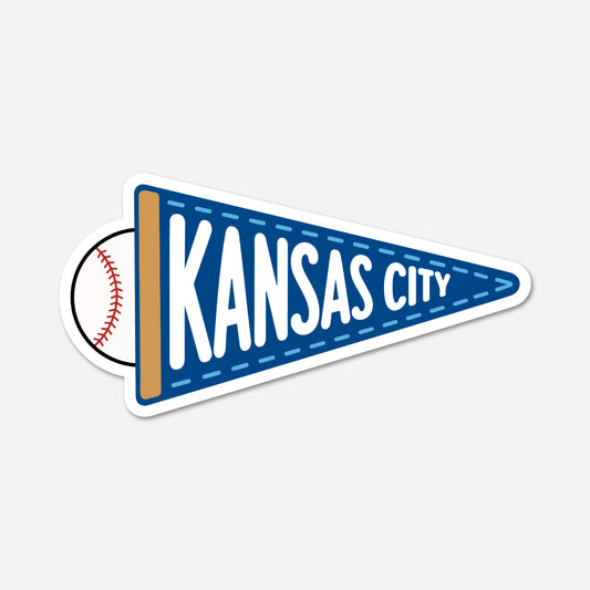 A die-cut sticker shaped like a blue football-style pennant with white text reading 'KANSAS CITY' and a baseball peeking out from behind on the left, shown on a light gray background.