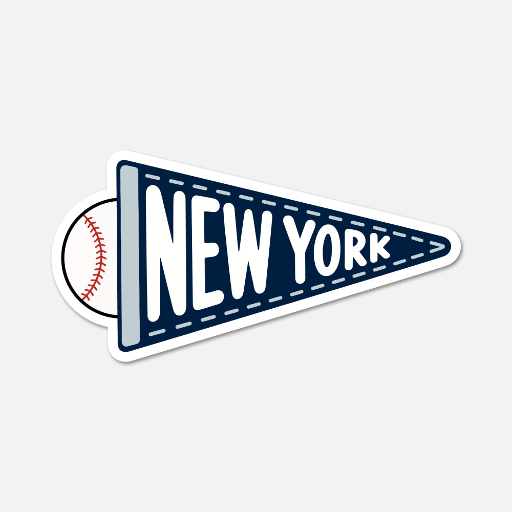 A die-cut sticker shaped like a navy blue pennant with white dashed stitching, the words "NEW YORK" in large white letters, and a baseball peeking out from behind on the left, shown on a light gray background.