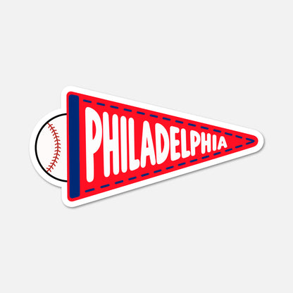 A die-cut sticker shaped like a red Philadelphia pennant with a baseball peeking out from behind it, shown on a light gray background.