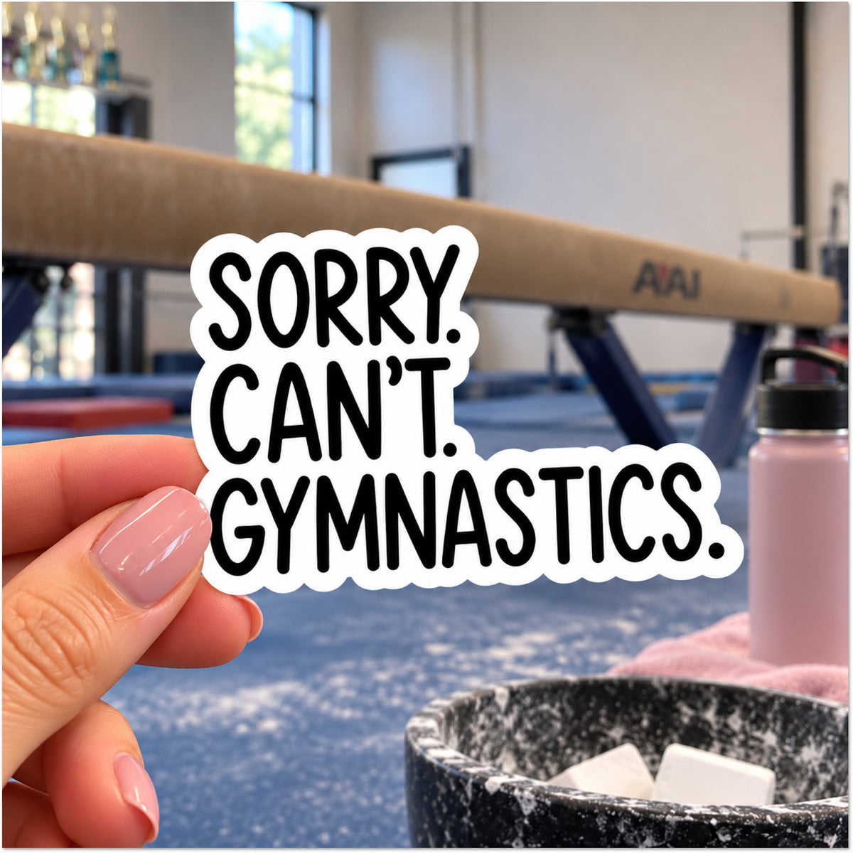 A hand with pink manicured nails holds a die-cut sticker that reads 'SORRY. CAN'T. GYMNASTICS.'
