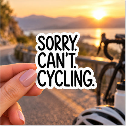 A hand holds a die-cut sticker that reads 'SORRY. CAN'T. CYCLING.'
