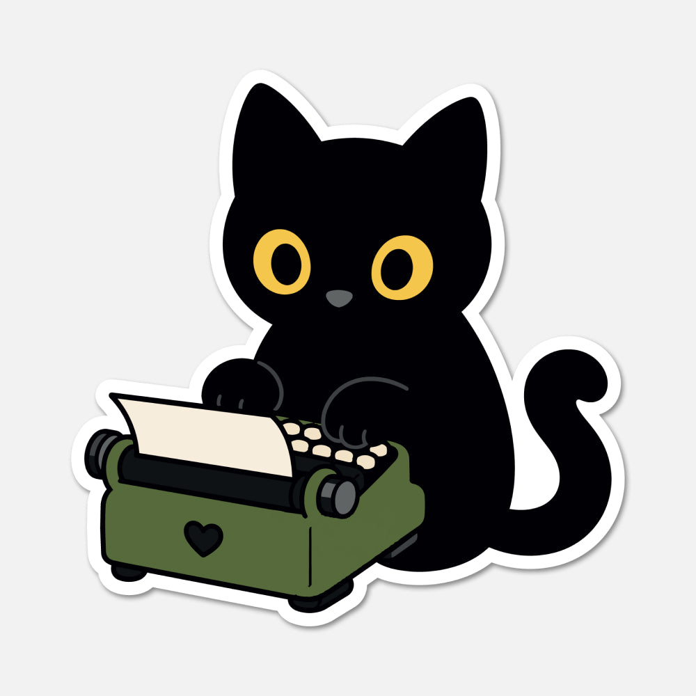 A die-cut sticker featuring a cute cartoon black cat with yellow eyes sitting at an olive green typewriter, shown on a light gray background.