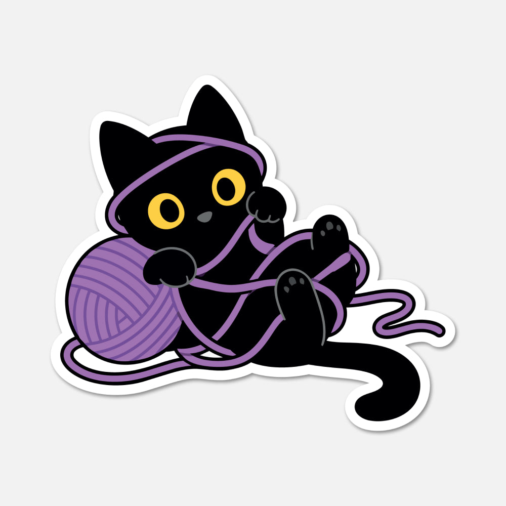 A cartoon die-cut sticker of a black cat wrapped in purple yarn, with yellow eyes, shown on a light gray background.
