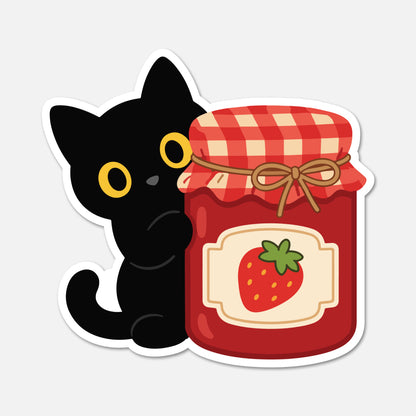 A die-cut sticker featuring a cute cartoon black cat peeking behind a red jam jar with a strawberry label and red-and-white gingham lid, shown on a light gray background.